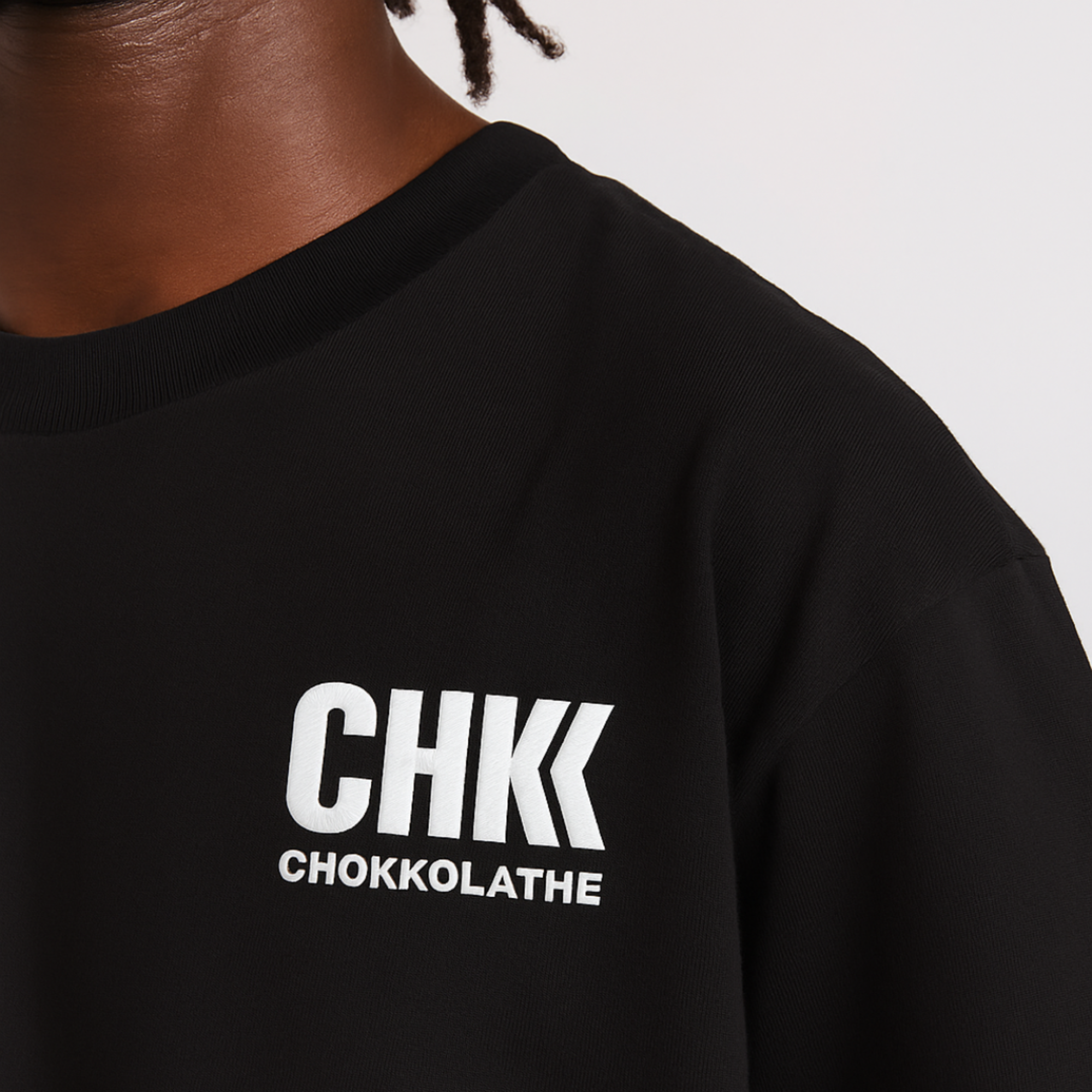 Black sweatshirt with 'CHKK CHOKKOLATHE' text on a neutral background