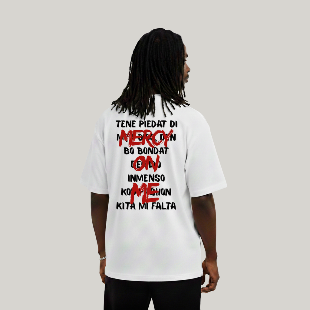 Person wearing a white t-shirt with text on the back against a plain background