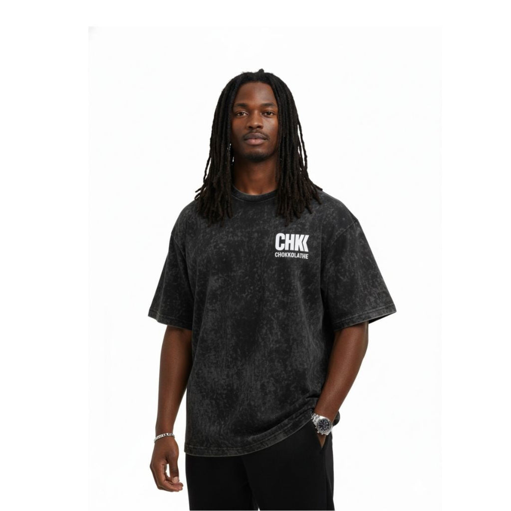 Person wearing a black t-shirt with a logo on a white background